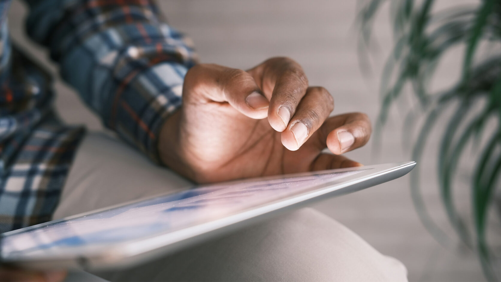Person looking at some analytics on a tablet.