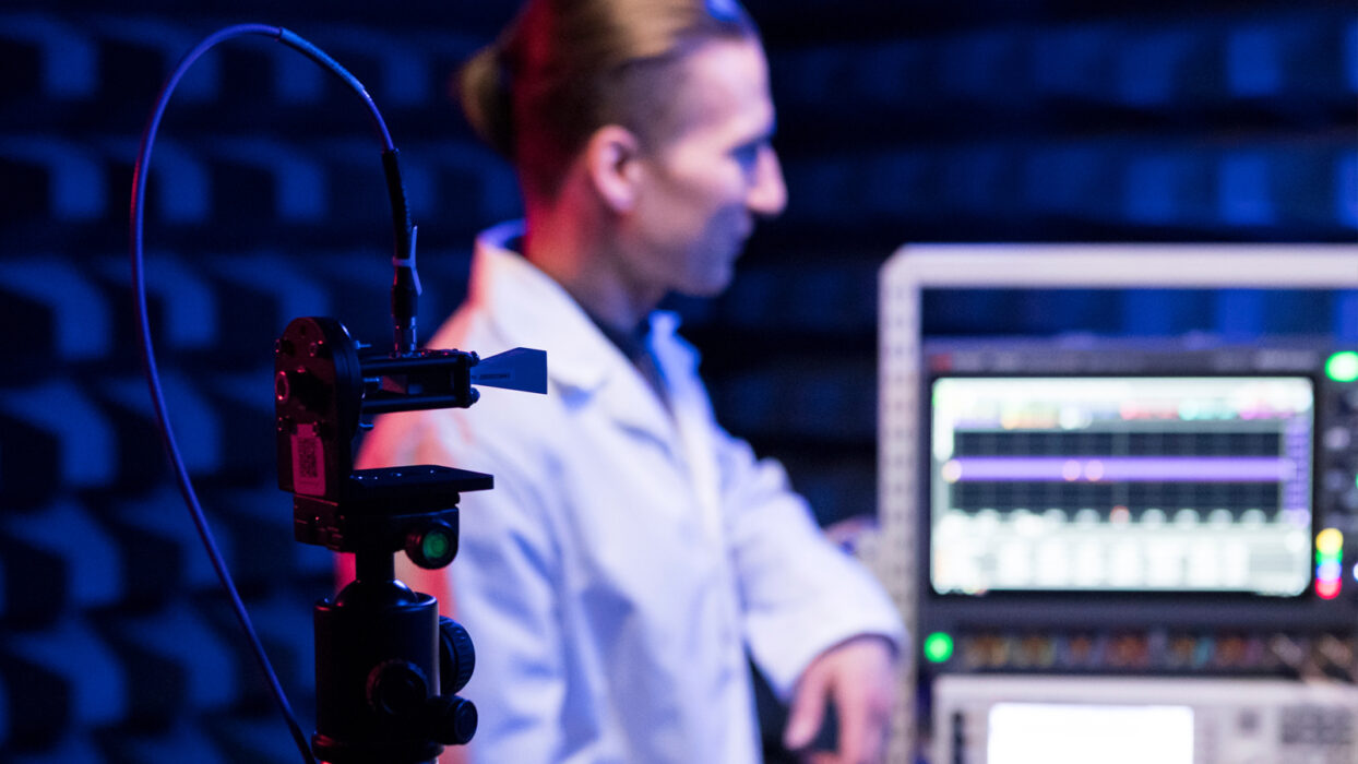 Researcher with RF-devices inside an anechoic chamber at the 6G Test Centre.