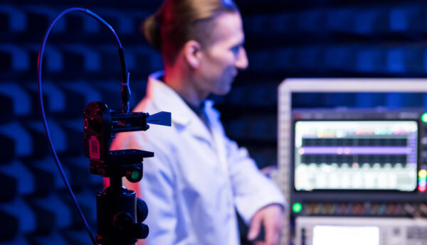 Researcher with RF-devices inside an anechoic chamber at the 6G Test Centre.